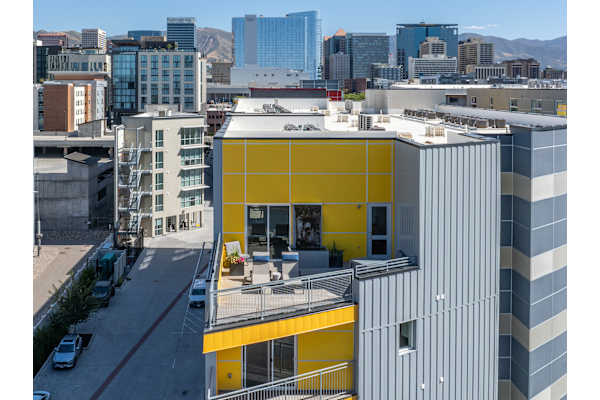 A yellow and grey building with a balcony in the middle. at Paperbox Lofts Apartments, Utah